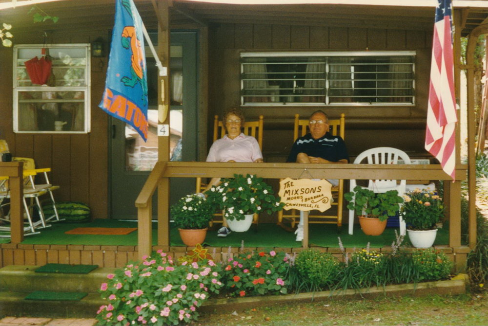 Mom and Dad on the front porch of their cabin